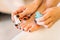 Female person hands with nail polish, pedicure