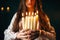 Female person holds candles in hands, divination