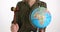 Female person holds Earth globe near judicial wooden gavel
