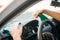 Female person polishes the dashboard of the car