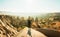 Female person stand with hands up over dramatic valley on hazy sunrise with fairy chimneys background. Solo exploration in Turkey