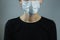 Female person in a surgical mask, minimalist and generic image.