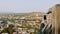 Female person take panorama photo of city. Over shoulder view of woman making video with smartphone device. Tbilisi city