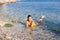 Female person in yellow lying in sea water