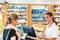 Female pharmacist advises young woman customer at the counter of a pharmacy