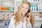 Female Pharmacist Communicating On Cordless Phone