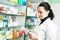Female pharmacist with prescription in drugstore