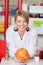 Female Pharmacist Selecting Medicine From Shelf