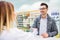 Female pharmacist serving a male customer.