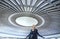 A female photographer admiring a huge circular concert hall ceiling