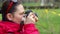 Female photographer shooting outdoors using vintage camera