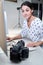 Female Photographer In Studio Reviewing Images From Photo Shoot On Computer