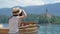 Female photographer takes photo of landscape of Lake Bled