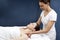 Female physiotherapist practising shoulder massage