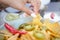 Female picking up a nacho chip with a blurred background