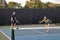 Female Pickleball Player Lunges for Ball