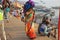Female Pilgrim Balancing Bundle Along Ganges River