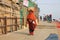 Female Pilgrim Carries Bundle On Her Head on Way to Next Temple