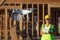 Female Pilot Flies Drone Quadcopter Inspecting Construction Site