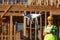 Female Pilot Flies Drone Quadcopter Inspecting Construction Site