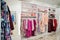 Female pink colorful clothing set of on the racks and shelves in clothing store brand new modern boutique. Spring summer dress