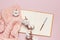 Female pink knitted sweater, cotton, open blank notebook, pen on pastel pink background top view flat lay. Lady winter Clothes. Co