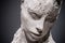 Female plaster sculpture on dark background