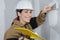 Female plasterer doing wall renovation with spatula and plaster