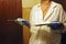 Female plasterer painter repairing a ceiling indoor