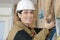 Female plasterer removing material