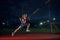 Female pole vaulter training at the stadium in the evening