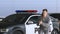 Female police officer aiming gun at running criminal, detaining thief, slow-mo