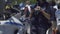 Female police officer standing next to motorbike, checking mobile phone on duty