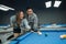 female pool player guided by the male pool player