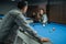 female pool player poking the white ball