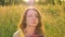 Female portrait of beautiful girl eating ripe strawberries during summer picnic on the field or meadow during sunrise