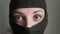 Female portrait of young girl wearing khaki balaclava, only eyes are visible, mandatory conscription, military, feminism