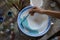 Female potter hand painting a bowl