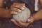 Female potter hands holds clay for pottery, selective focus