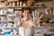 Female potter shows hands covered with dried clay