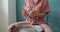 Female potter sitting and throws piece of pottery clay on the working desk. Woman making ceramic item. Pottery preparing