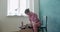 Female potter sitting and throws piece of pottery clay on the working desk. Woman making ceramic item. Pottery preparing