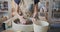 Female potter starts work with clay on pottery wheel.