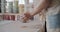 Female potter throws piece of pottery clay on the working desk close-up