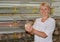 The female poultry breeder holds in hand a quail (focus on a bir