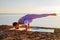 Female practicing variation of Mayurasana, Peacock pose. Hand-balancing asana in hatha yoga. Strong healthy body. Bali, Indonesia