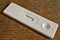 Female pregnancy test with two stripes as a positive confirmation of baby expectation