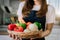 Female prepares cooking healthy food from fresh vegetables and fruits in kitchen room