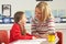 Female Primary School Pupil And Teacher Working