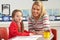 Female Primary School Pupil And Teacher Working